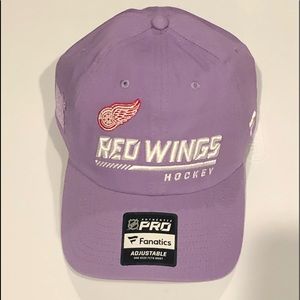 New Detroit Red Wings “Hockey Fights Cancer” hat with stickers. Never Worn.